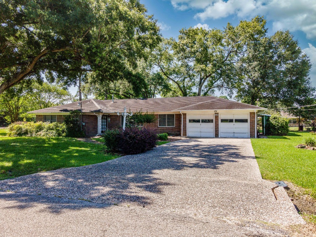 718 Nelson Street Crosby, TX 77532 - Photo 2 of 38 a front view of a house with a garden