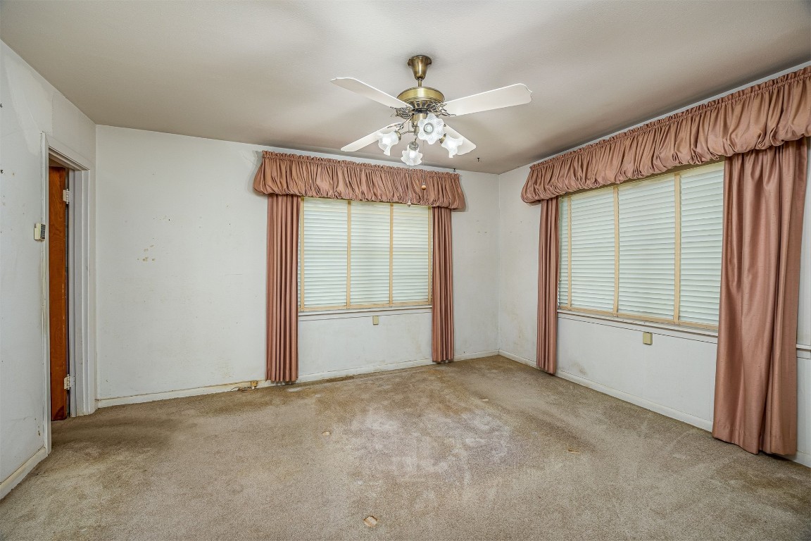 718 Nelson Street Crosby, TX 77532 - Photo 25 of 38 an empty room with chandelier fan and windows