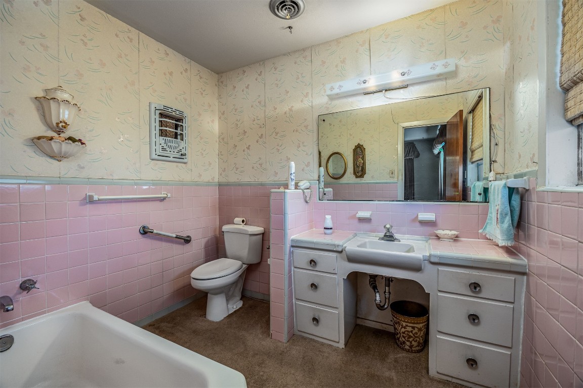 718 Nelson Street Crosby, TX 77532 - Photo 27 of 38 a bathroom with a sink a toilet and a mirror