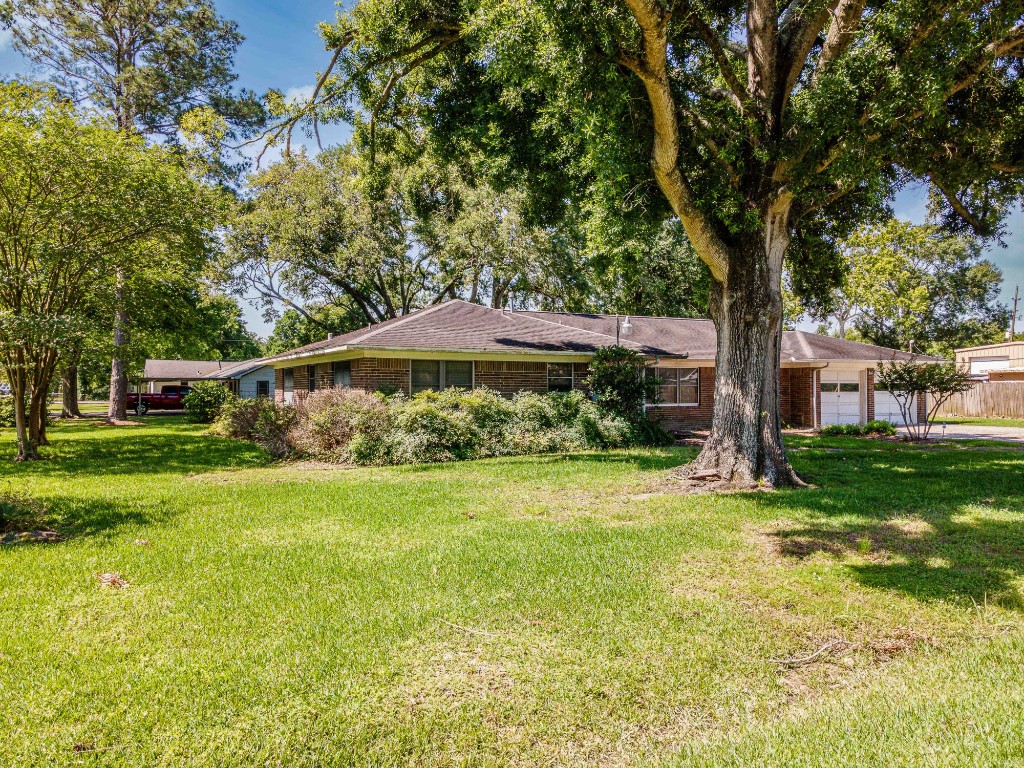 718 Nelson Street Crosby, TX 77532 - Photo 3 of 38 a view of a house with a yard