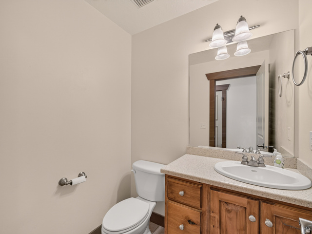 1279 West 1500th Street North Mapleton, UT 84664 - Photo 34 of 83 Bathroom featuring a wooden vanity with a light-toned countertop, oval sink, and chrome faucet