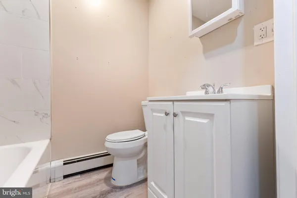 a bathroom with a sink a toilet and vanity