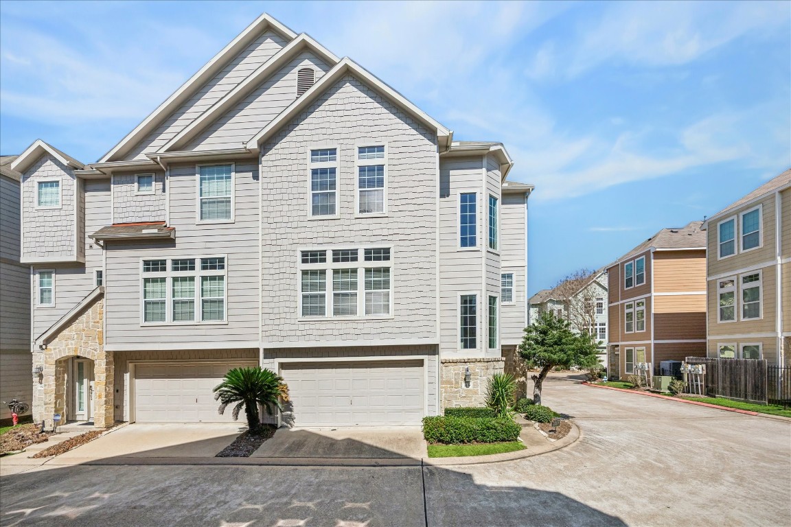 a front view of a house with a yard and potted plants
