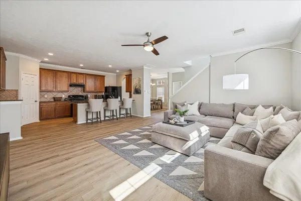 a living room with furniture and a kitchen view