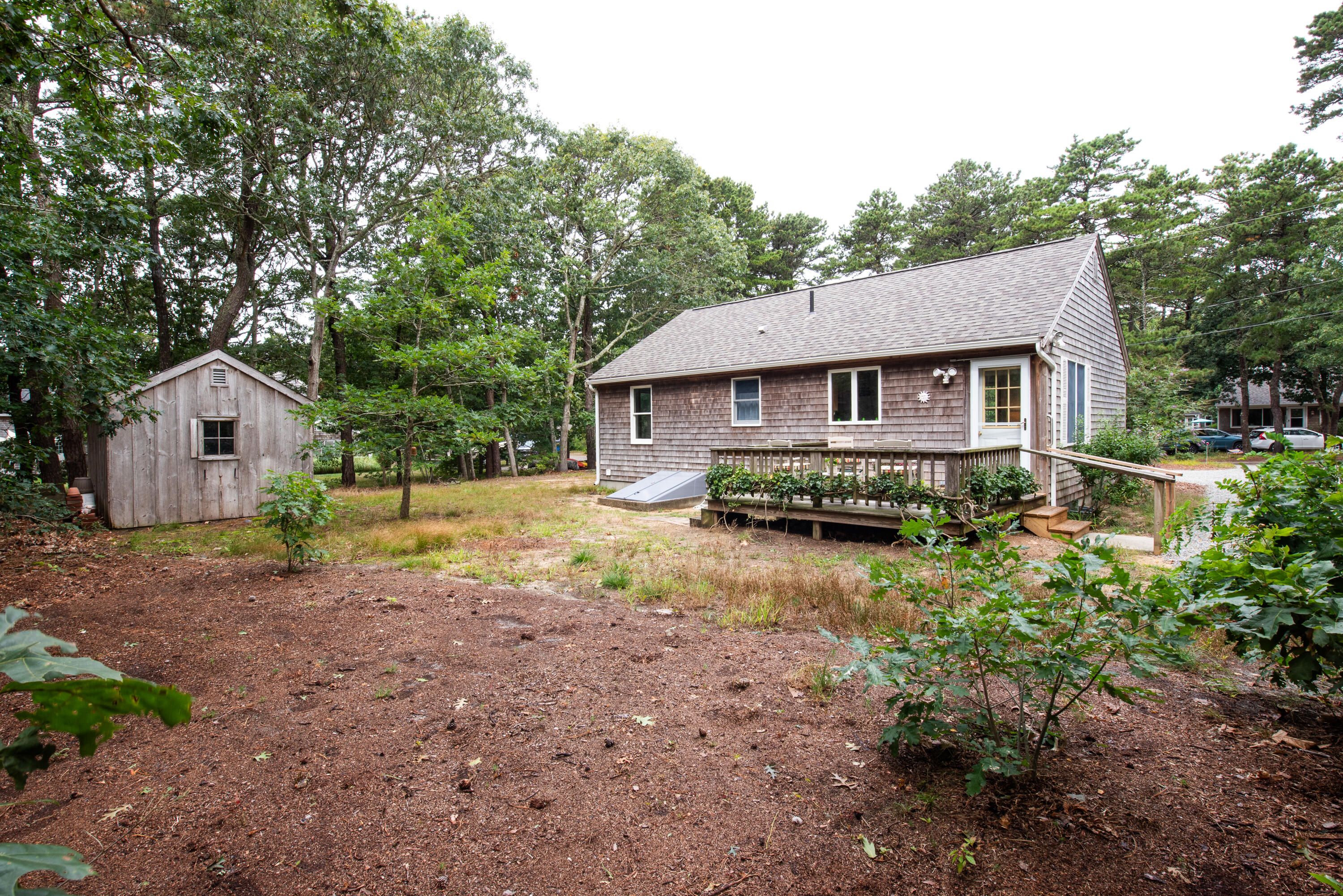 100 Gigi Lane Eastham, MA 02642 - Photo 27 of 30 a view of a house with backyard and trees