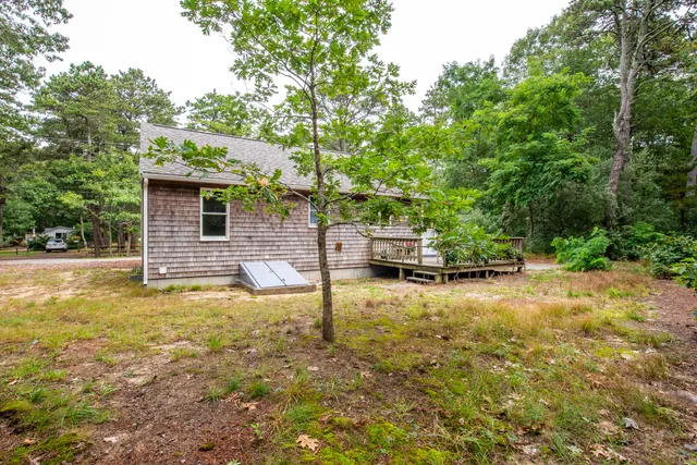 a view of a house with backyard and sitting area