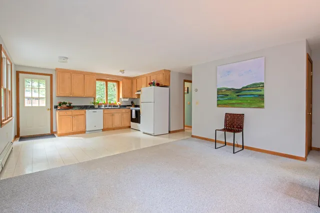 a kitchen with granite countertop a stove top oven sink and cabinets