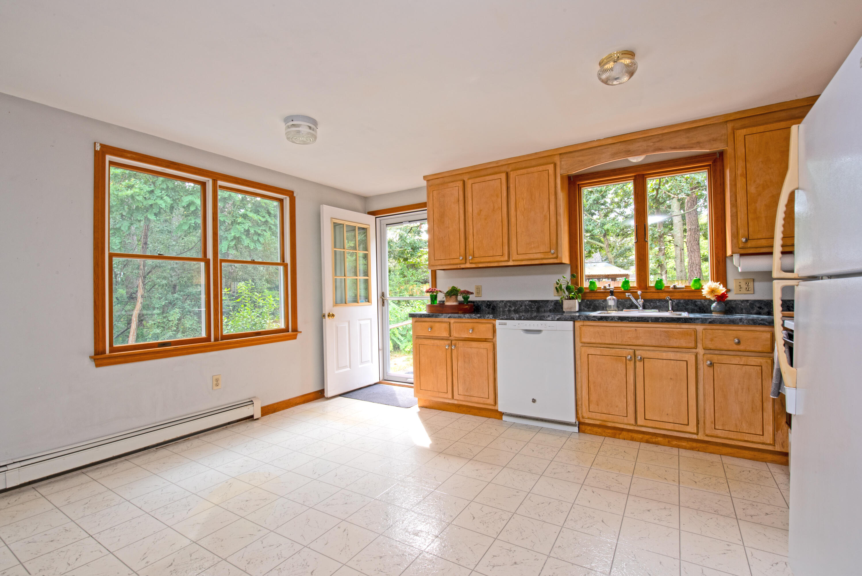 100 Gigi Lane Eastham, MA 02642 - Photo 5 of 30 a kitchen with granite countertop a stove top oven sink and cabinets