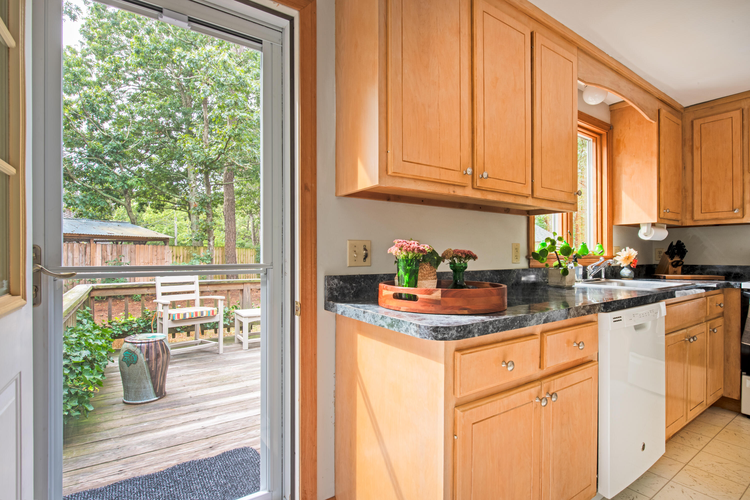 100 Gigi Lane Eastham, MA 02642 - Photo 6 of 30 a kitchen with stainless steel appliances granite countertop white cabinets and a window