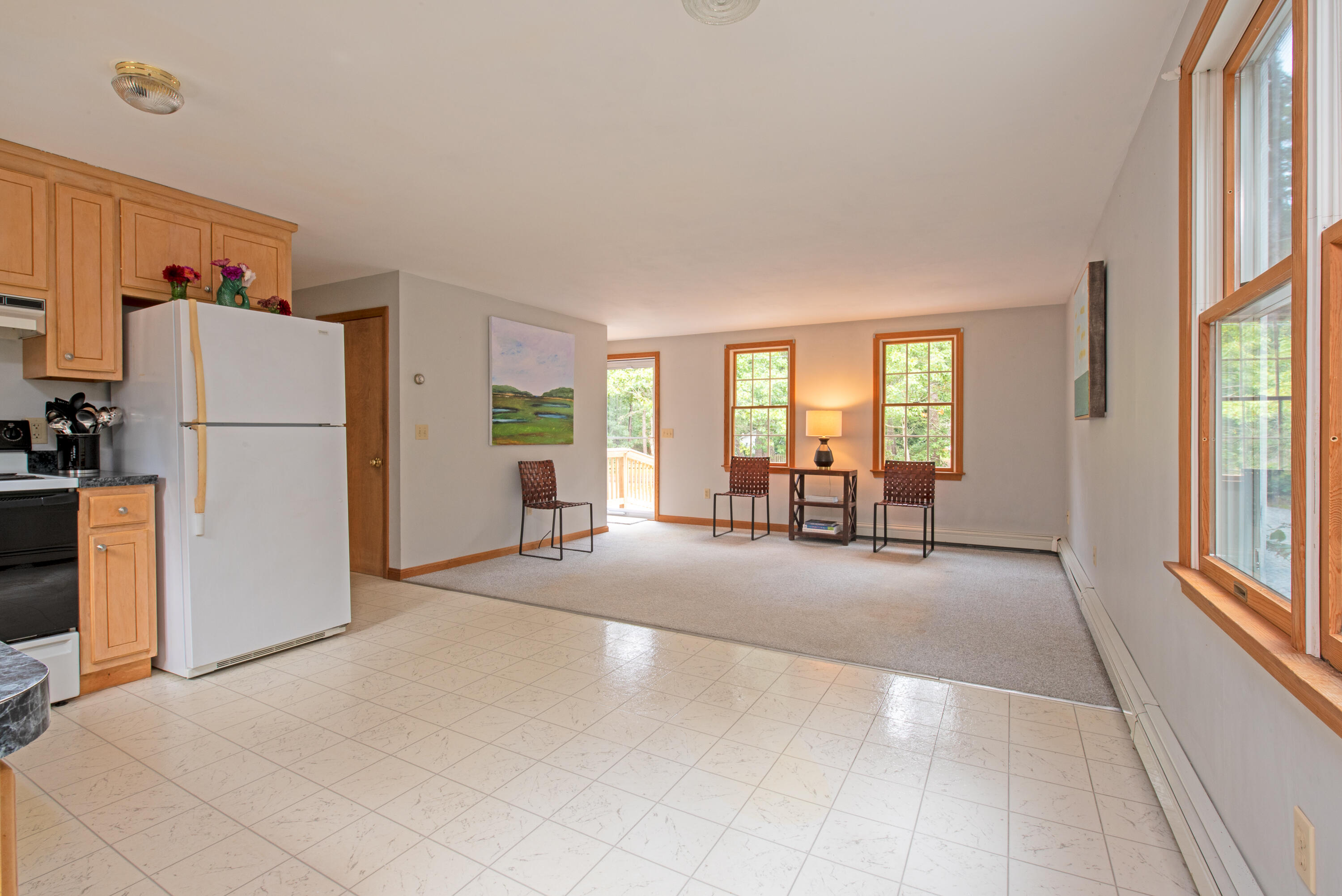 100 Gigi Lane Eastham, MA 02642 - Photo 8 of 30 a view of a livingroom with furniture a ceiling fan and refrigerator