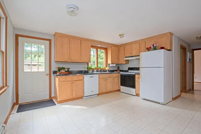 a view of a livingroom with furniture and a window