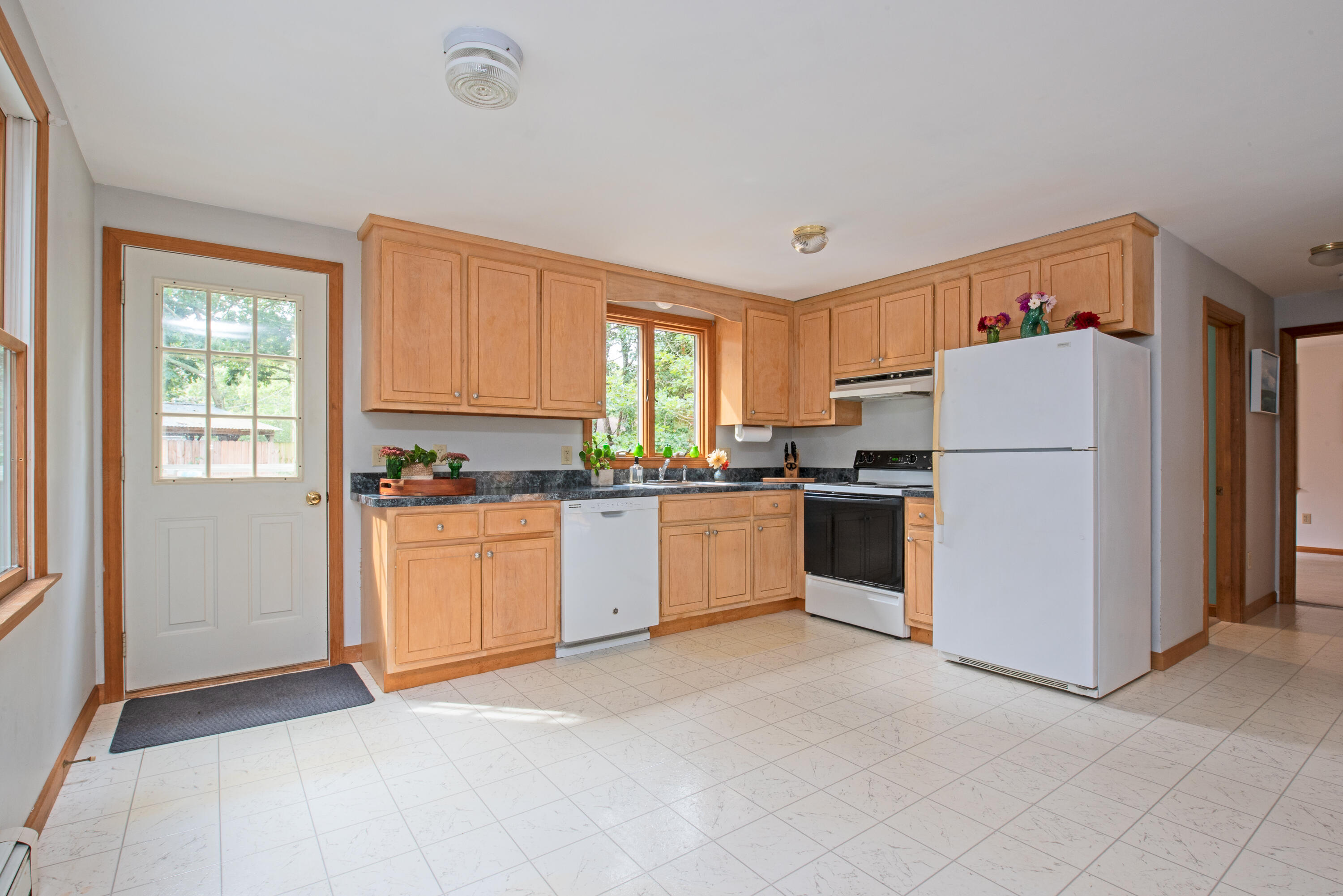 100 Gigi Lane Eastham, MA 02642 - Photo 9 of 30 a kitchen with white cabinets and white appliances