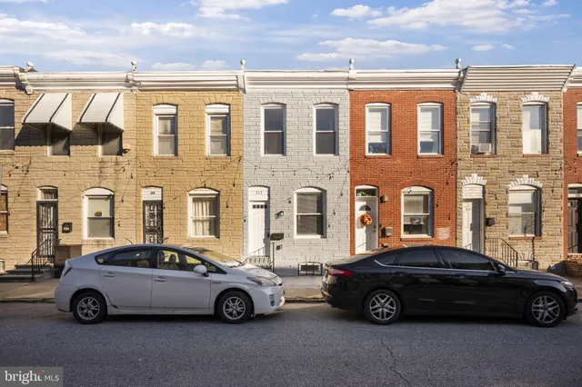 a car parked in front of a brick building