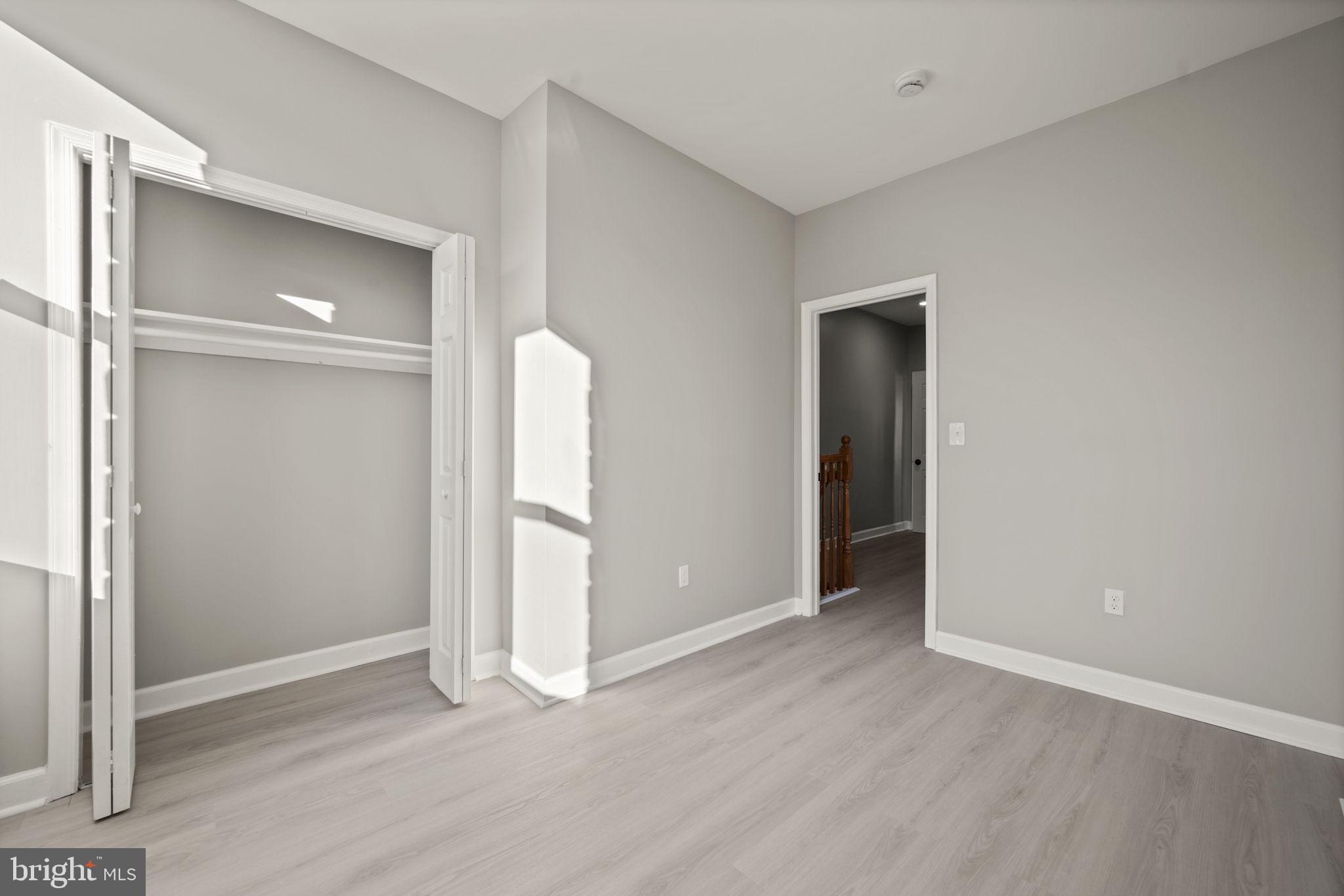 217 North Port Street Baltimore, MD 21224 - Photo 17 of 31 an empty room with closet and wooden floor