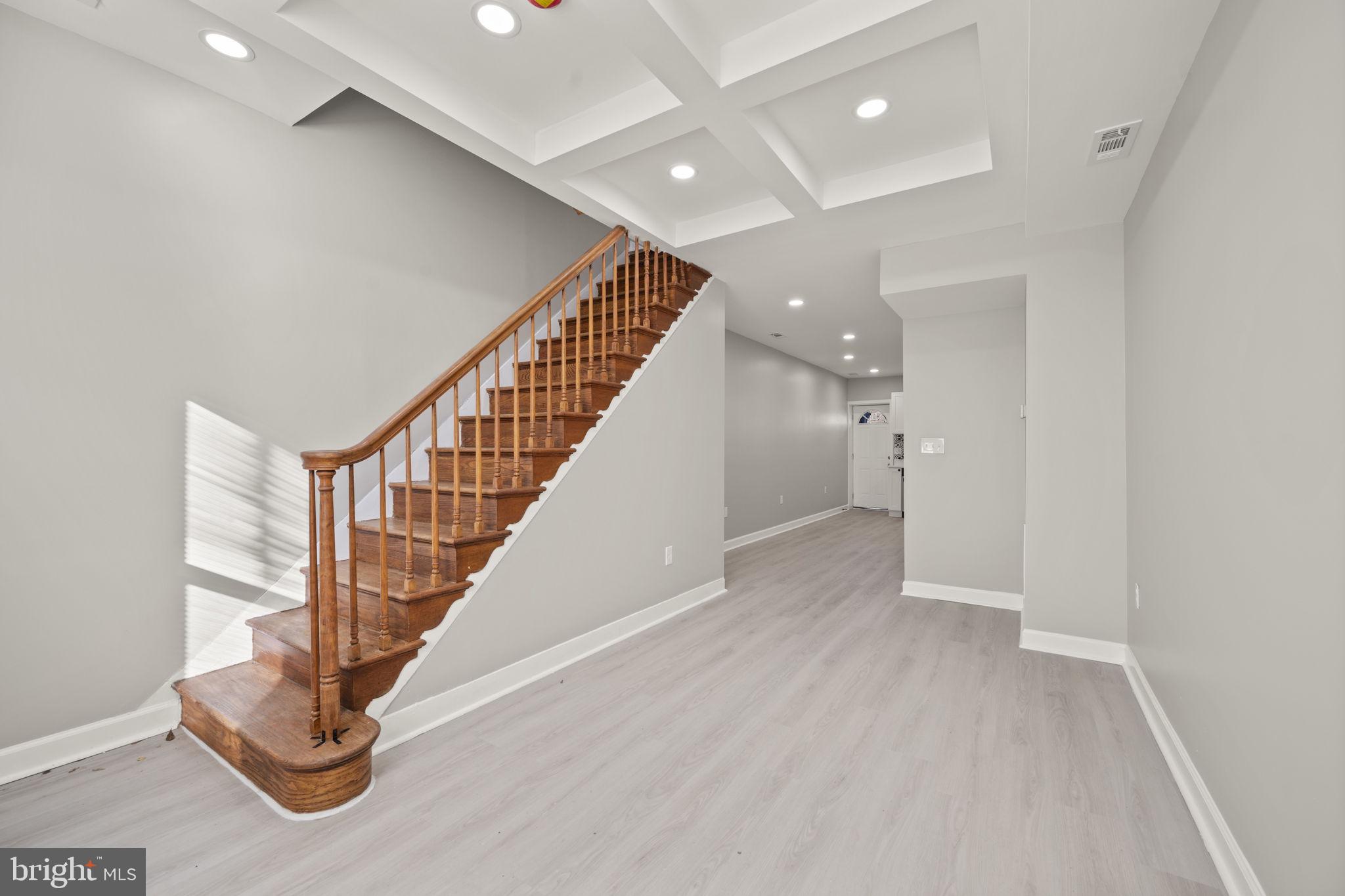 217 North Port Street Baltimore, MD 21224 - Photo 2 of 31 a view of entryway with stairs and wooden floor