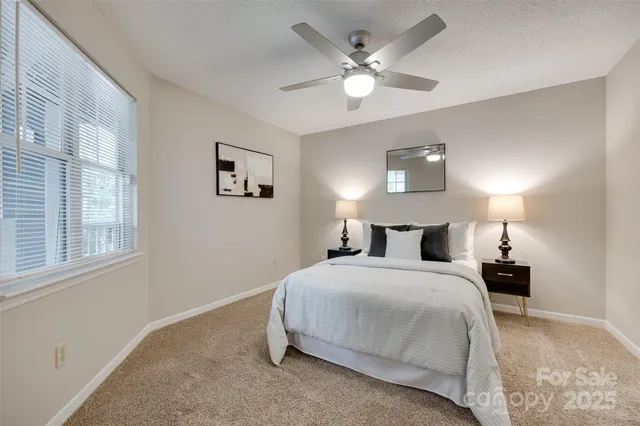 a spacious bedroom with a bed and a chandelier