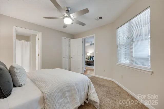 a spacious bedroom with a bed and a chandelier
