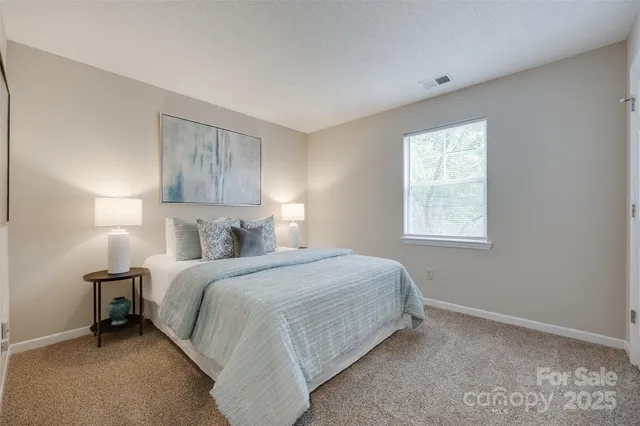 a bedroom with a bed lamp and a window