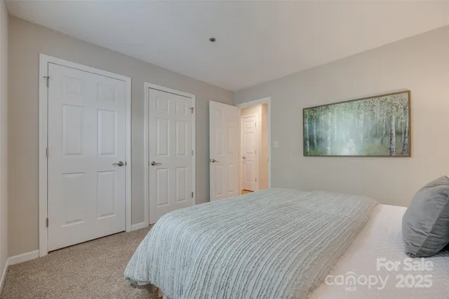 a bedroom with a bed and a painting