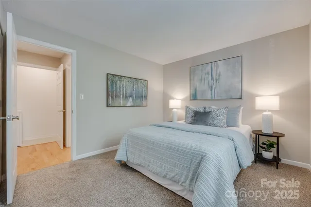 a bedroom with a bed and a lamp