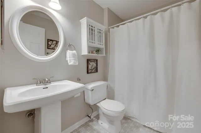 a bathroom with a toilet a sink and a mirror