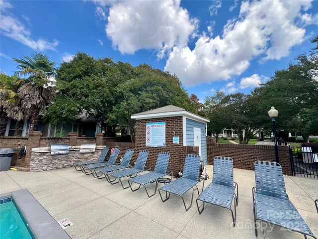 a view of a house with backyard and sitting area