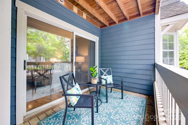 a view of balcony with wooden floor and outdoor seating