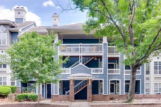 a view of a patio with table and chairs and potted plants