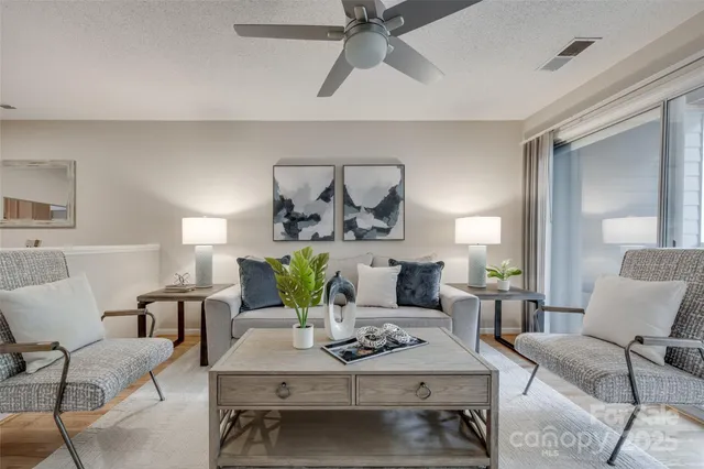 a living room with furniture and view of kitchen