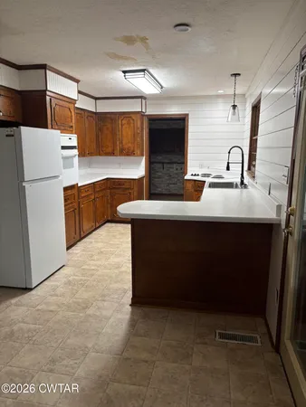 a kitchen with stainless steel appliances a sink and a refrigerator