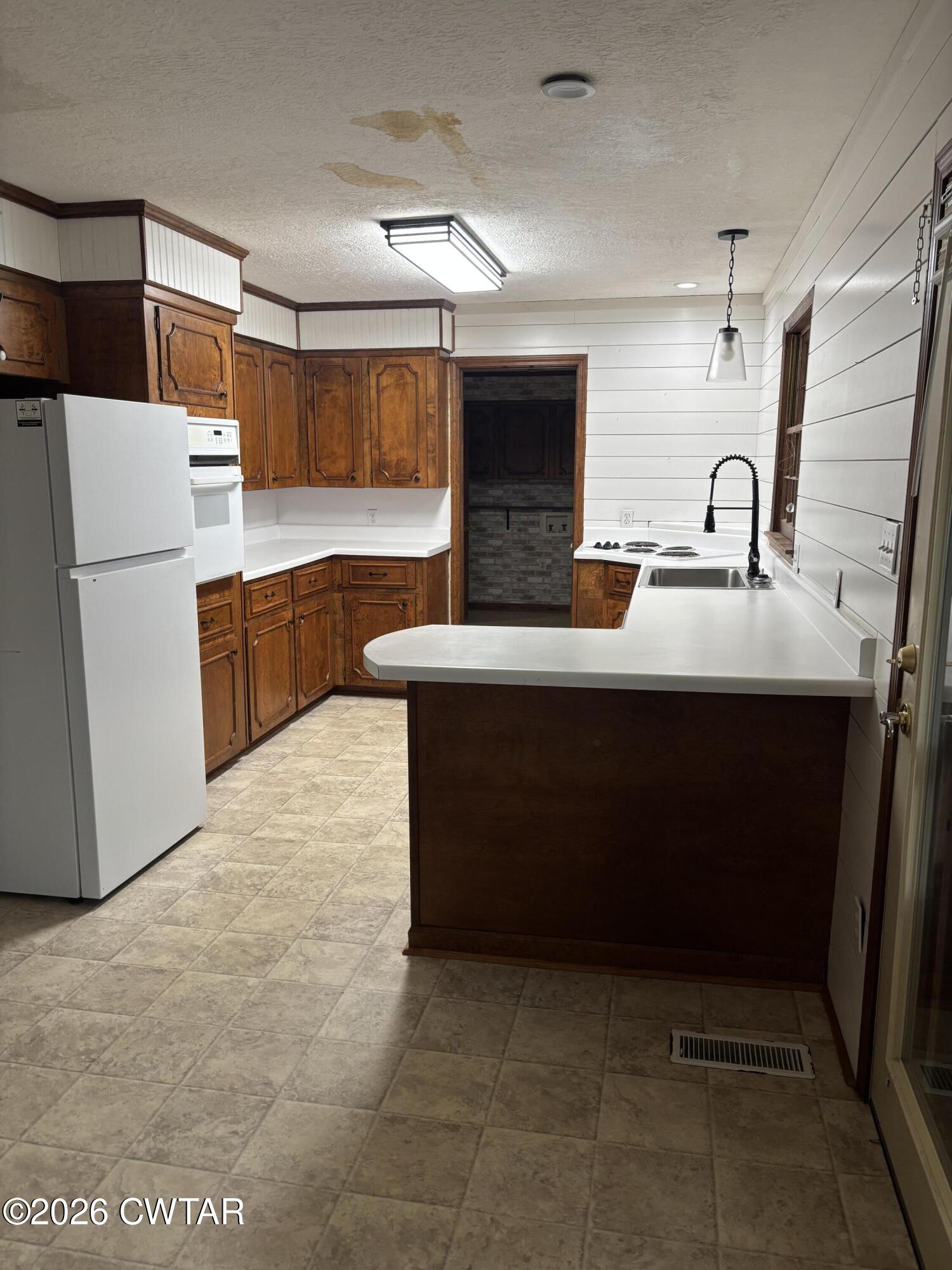119 Casey Road Pinson, TN 38366 - Photo 7 of 10 a kitchen with stainless steel appliances a sink and a refrigerator