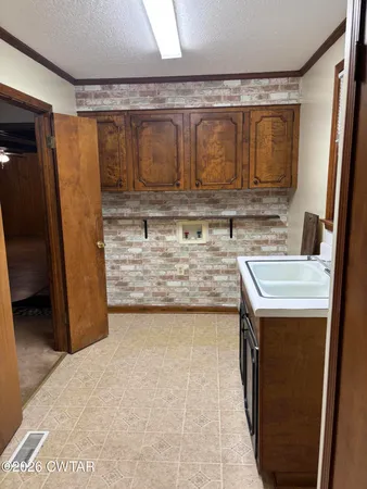 a bathroom with a granite countertop sink a mirror and shower