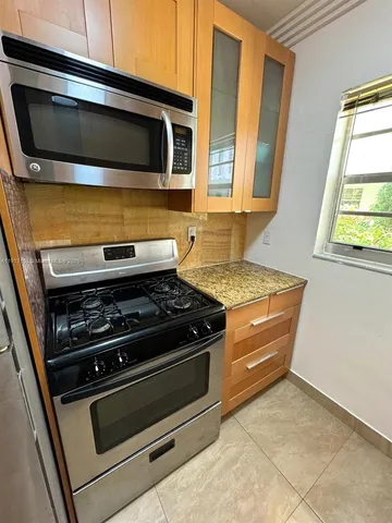 a kitchen with a stove and a microwave