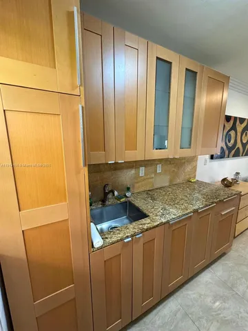 a kitchen with stainless steel appliances granite countertop cabinets and sink