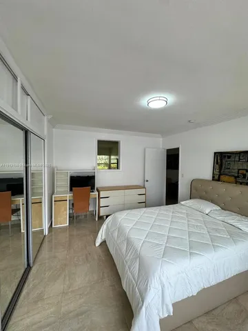 a bedroom with a bed and a table