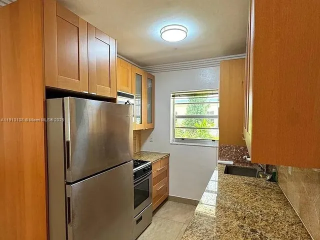 a refrigerator freezer sitting inside of a kitchen