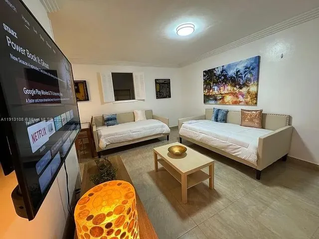 a bedroom with furniture and a flat screen tv