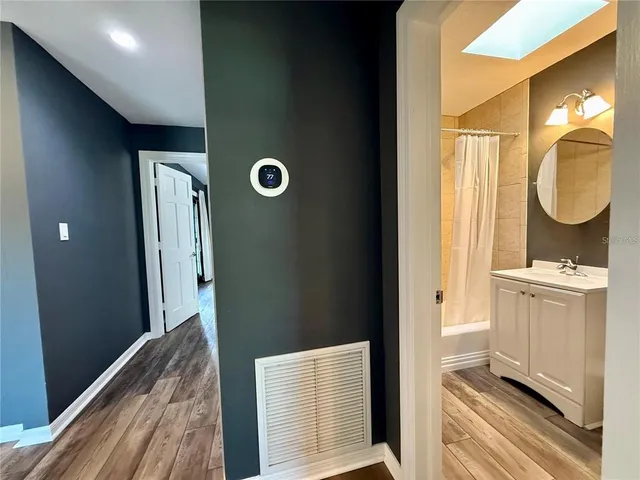 a bathroom with a sink a mirror and a shower