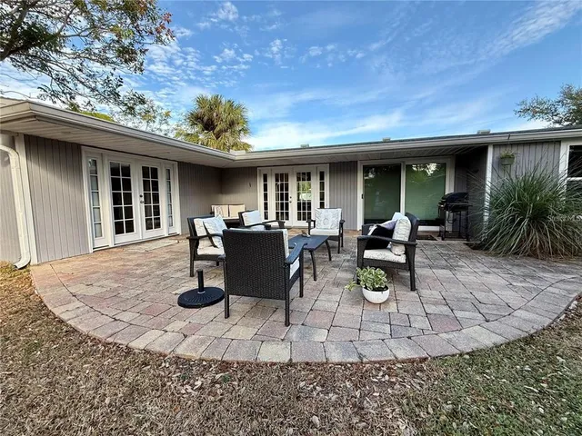 a view of a patio with dining table and chairs