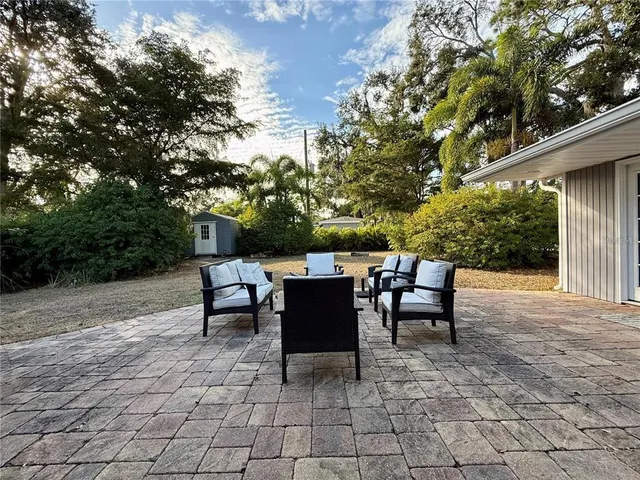 a backyard of a house with yard and outdoor seating