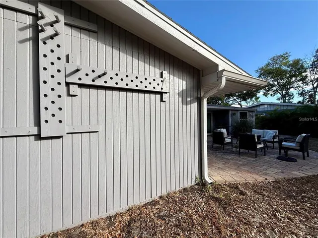 a backyard of a house with table and chairs