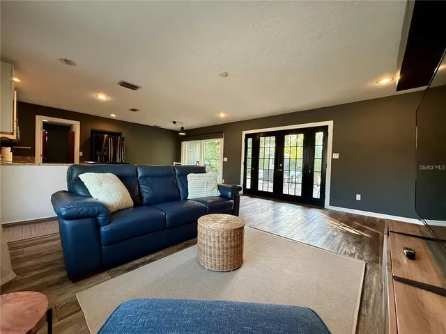 a living room with furniture and a large window