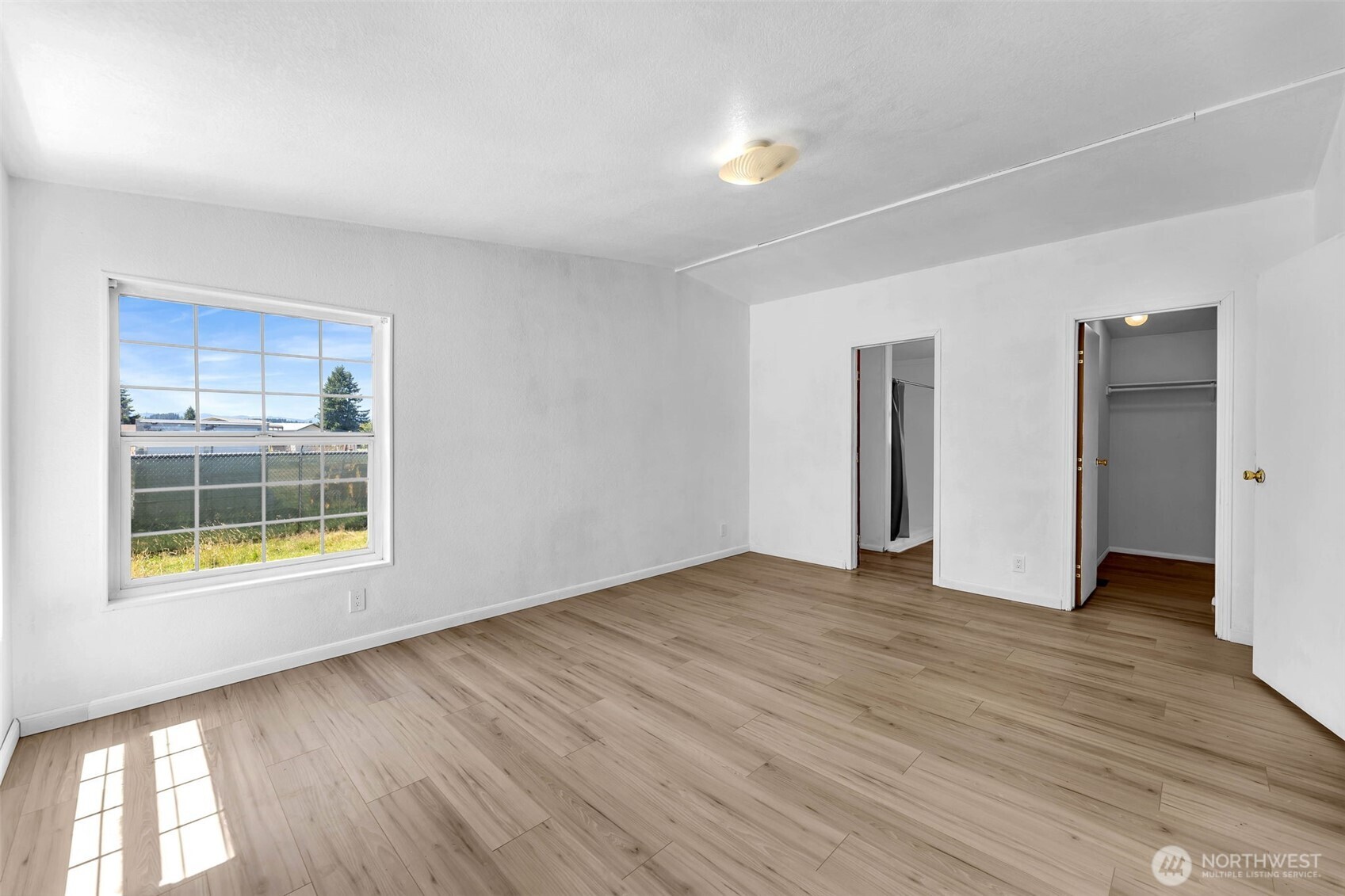 241 Foster Creek Road, Unit B Toledo, WA 98591 - Photo 11 of 22 a view of an empty room with wooden floor and a window