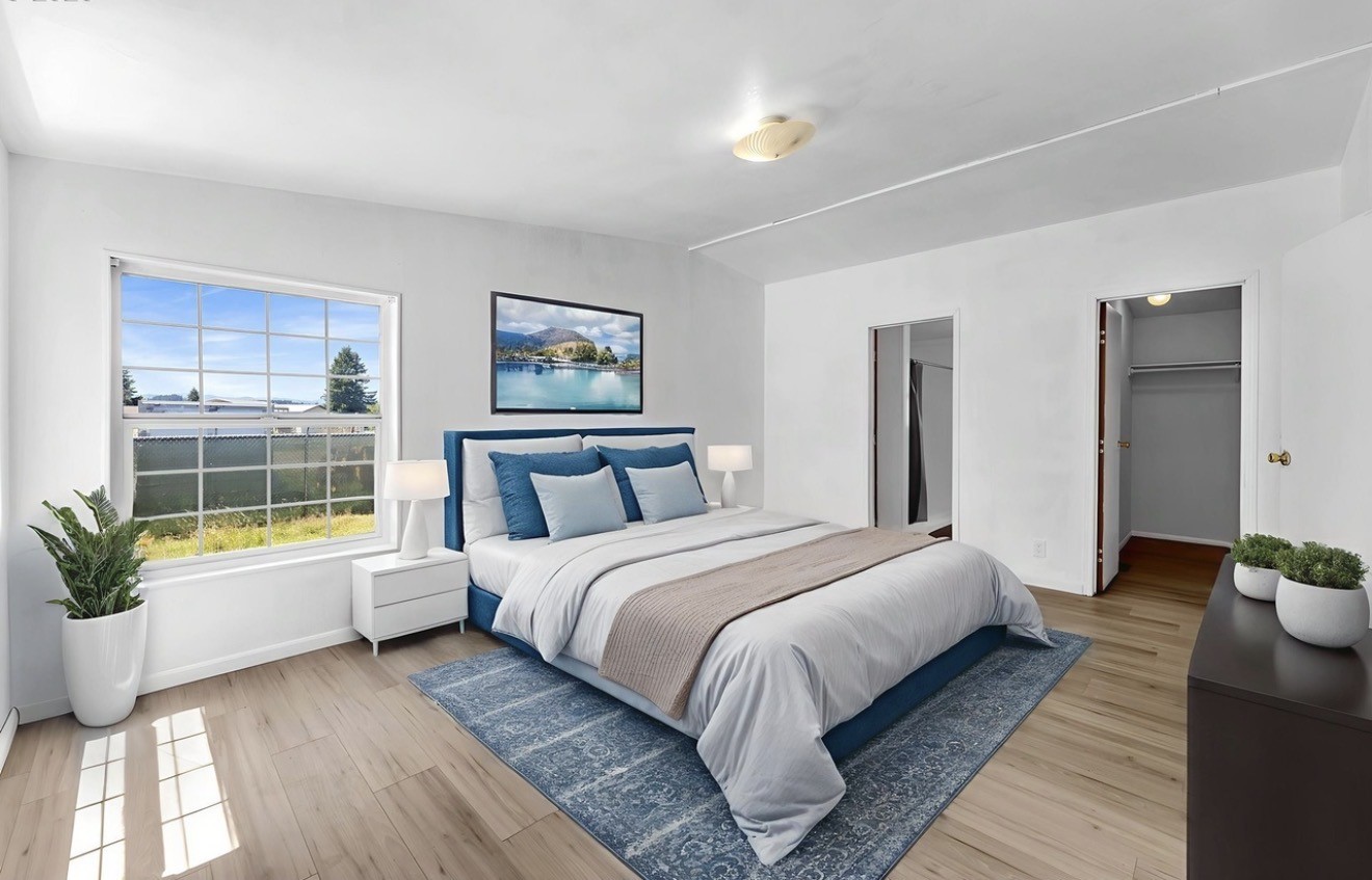 241 Foster Creek Road, Unit B Toledo, WA 98591 - Photo 12 of 22 a spacious bedroom with a large bed a chandelier and windows