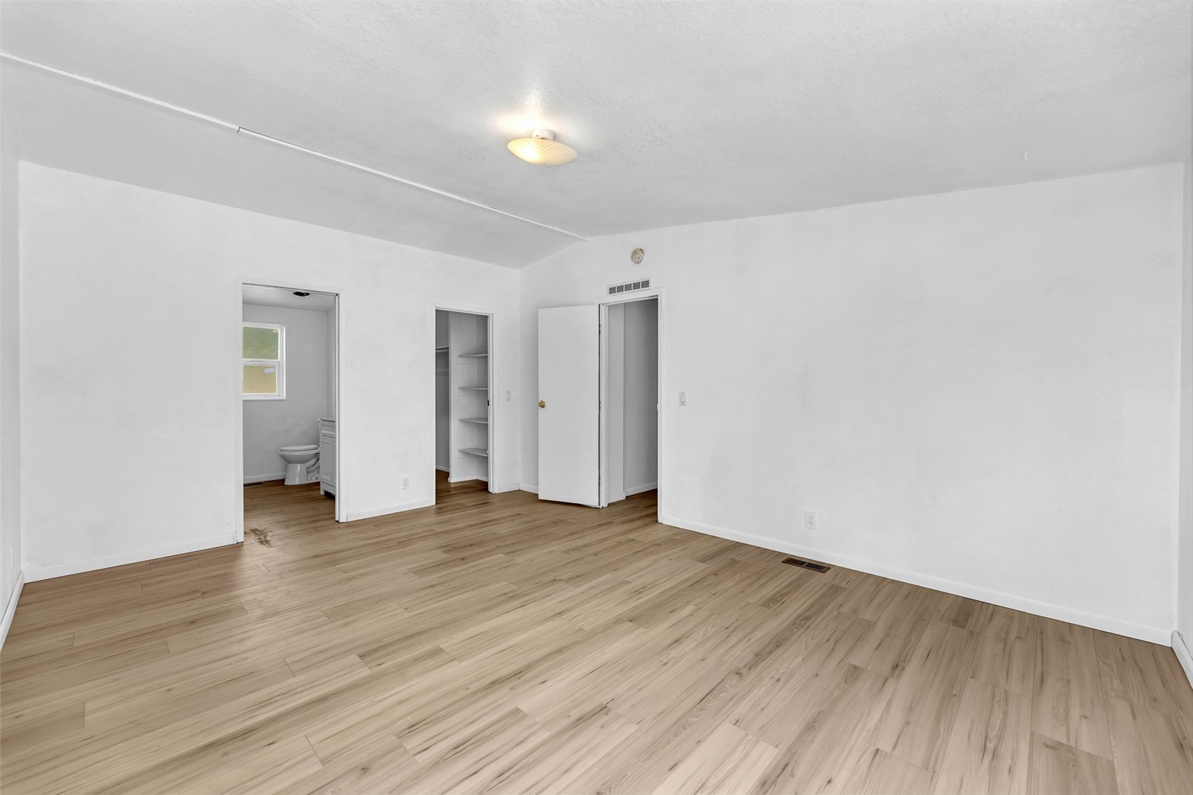 241 Foster Creek Road, Unit B Toledo, WA 98591 - Photo 13 of 22 a view of an empty room with wooden floor