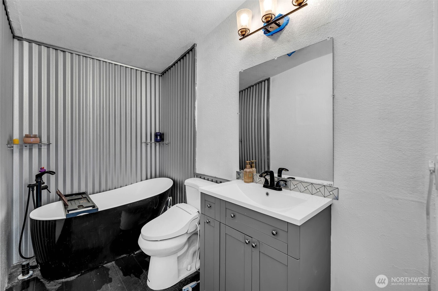 241 Foster Creek Road, Unit B Toledo, WA 98591 - Photo 16 of 22 a bathroom with a sink a toilet a mirror and shower