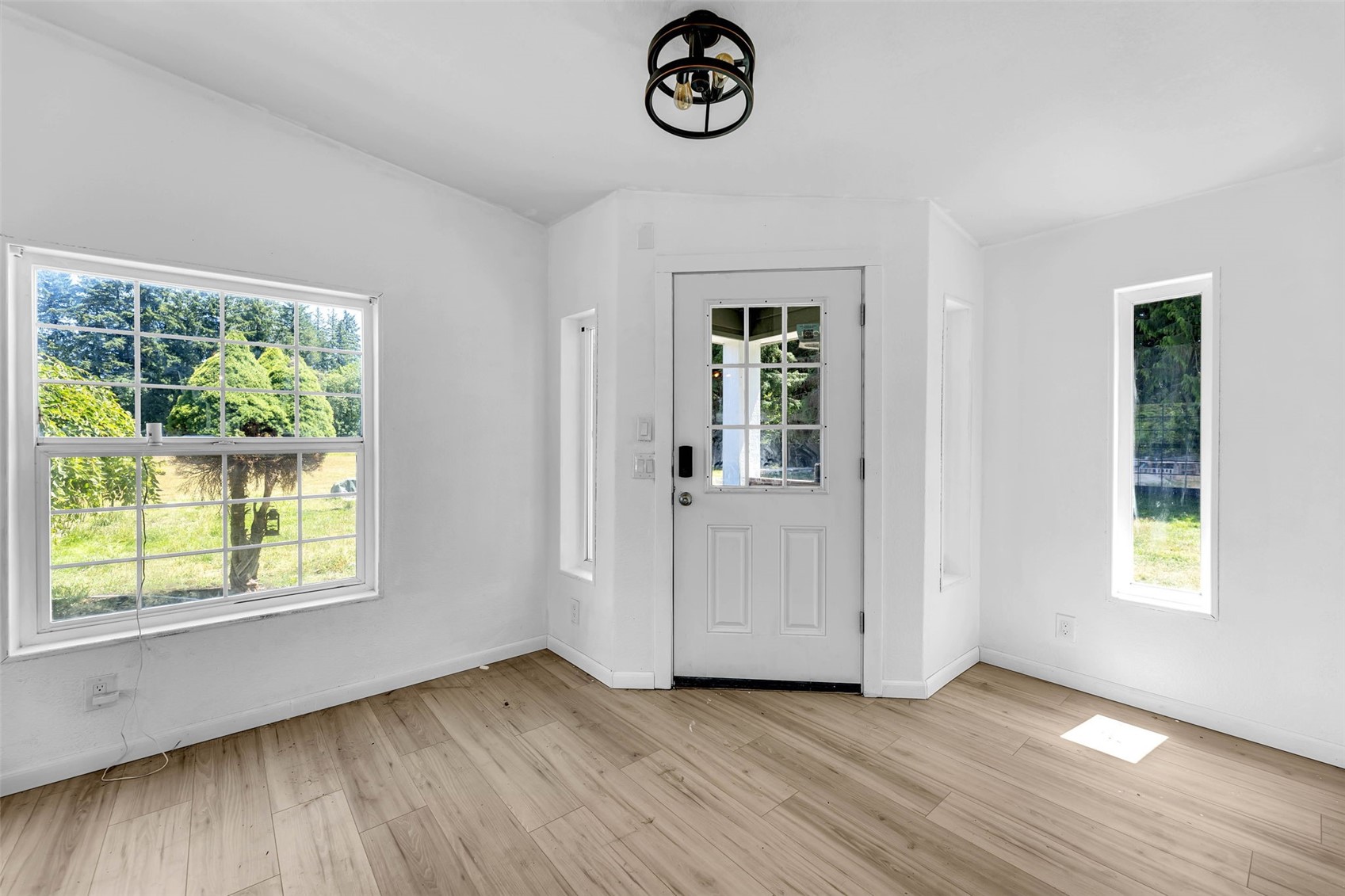 241 Foster Creek Road, Unit B Toledo, WA 98591 - Photo 6 of 22 an empty room with wooden floor and windows