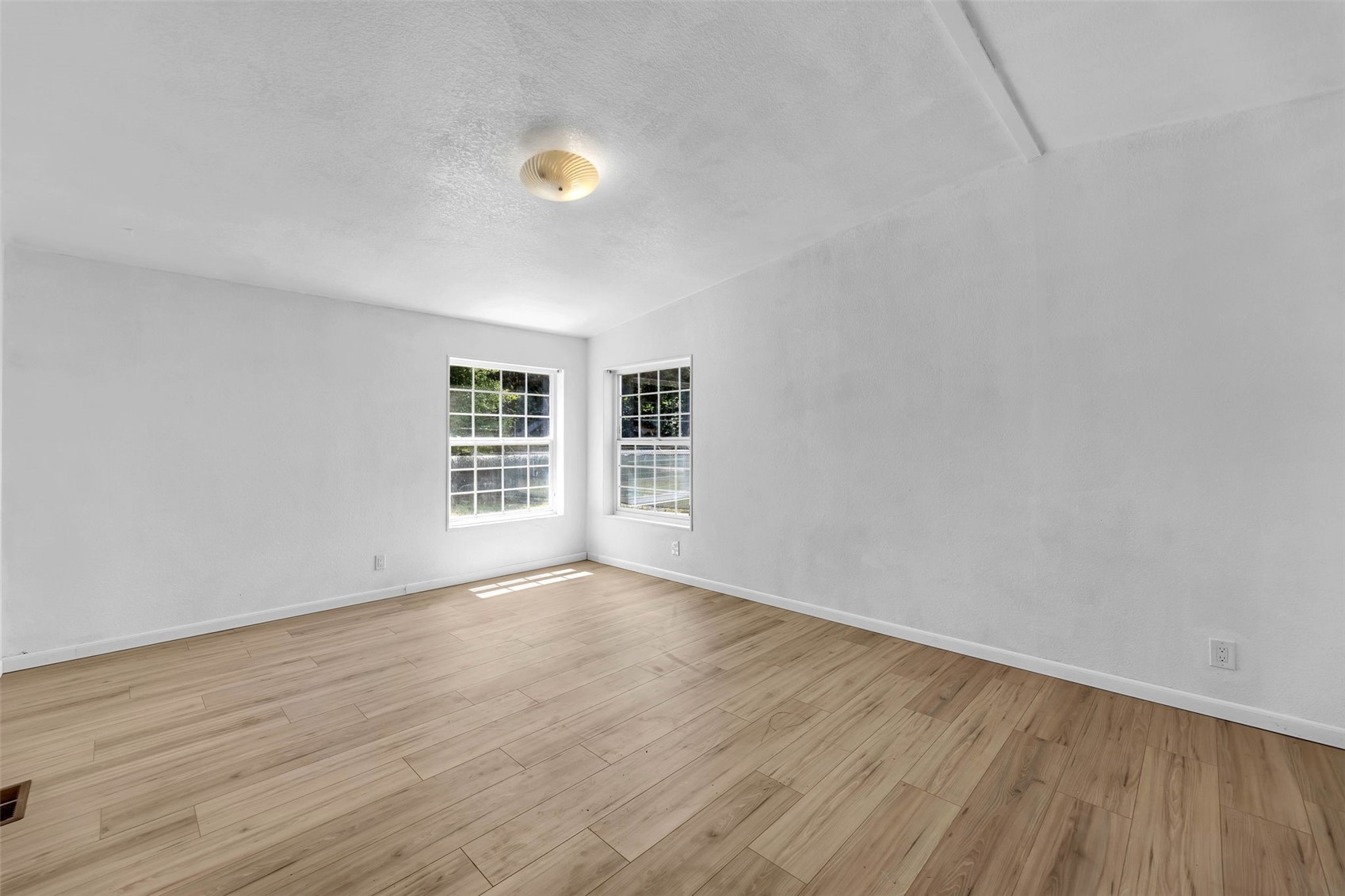 241 Foster Creek Road, Unit B Toledo, WA 98591 - Photo 7 of 22 a view of an empty room with wooden floor and a window