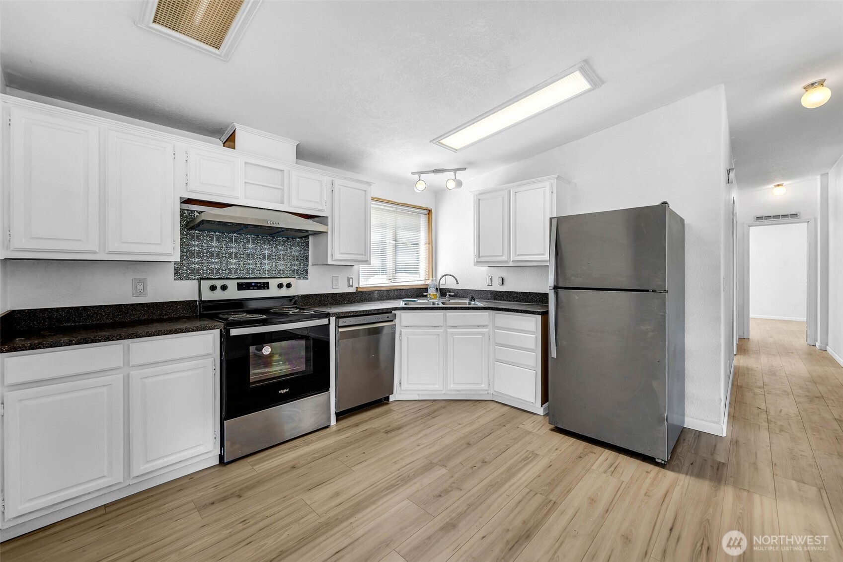 241 Foster Creek Road, Unit B Toledo, WA 98591 - Photo 9 of 22 a kitchen with granite countertop a refrigerator stove top oven and sink