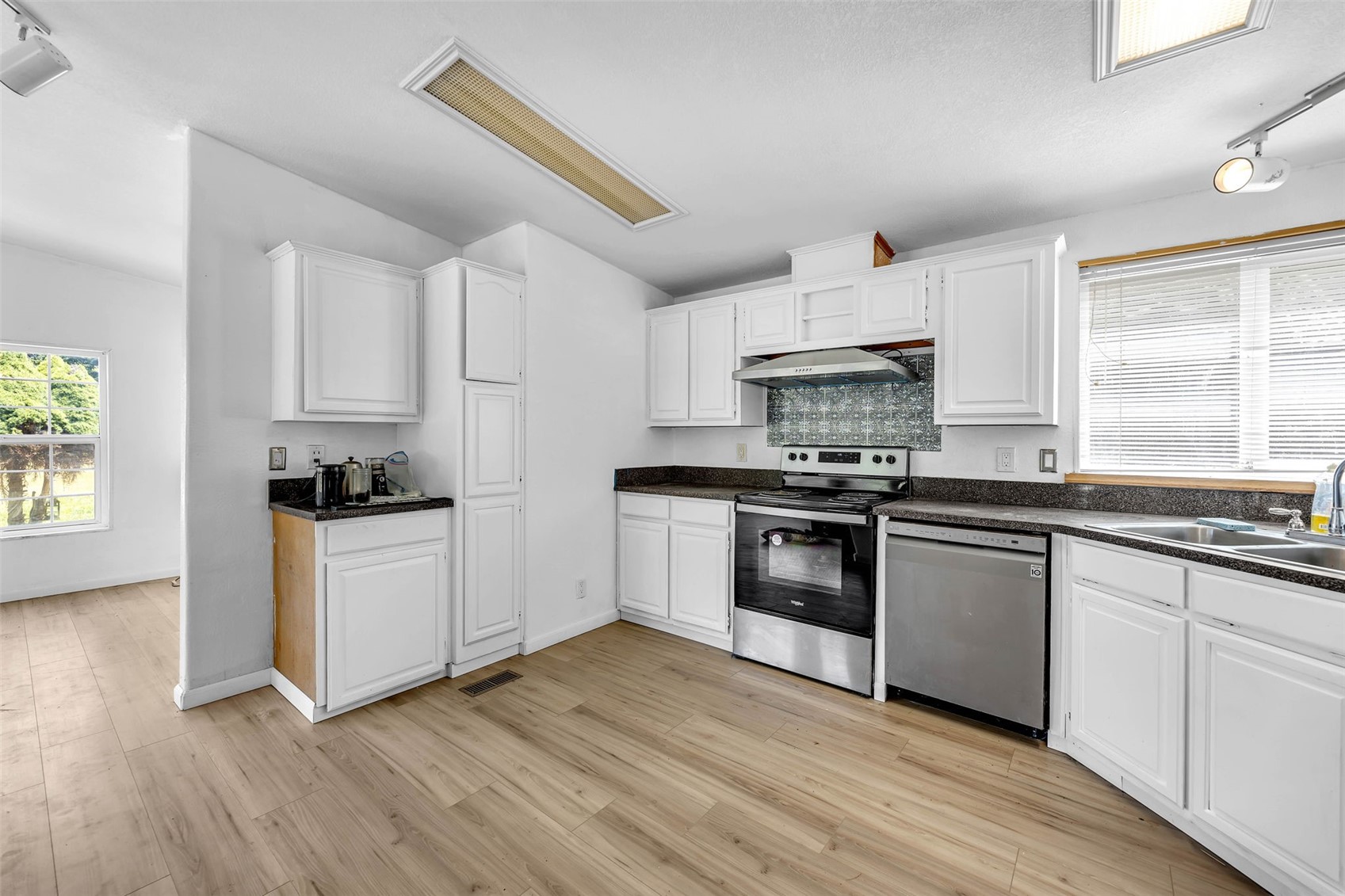 241 Foster Creek Road, Unit B Toledo, WA 98591 - Photo 10 of 22 a kitchen with granite countertop white cabinets and white appliances